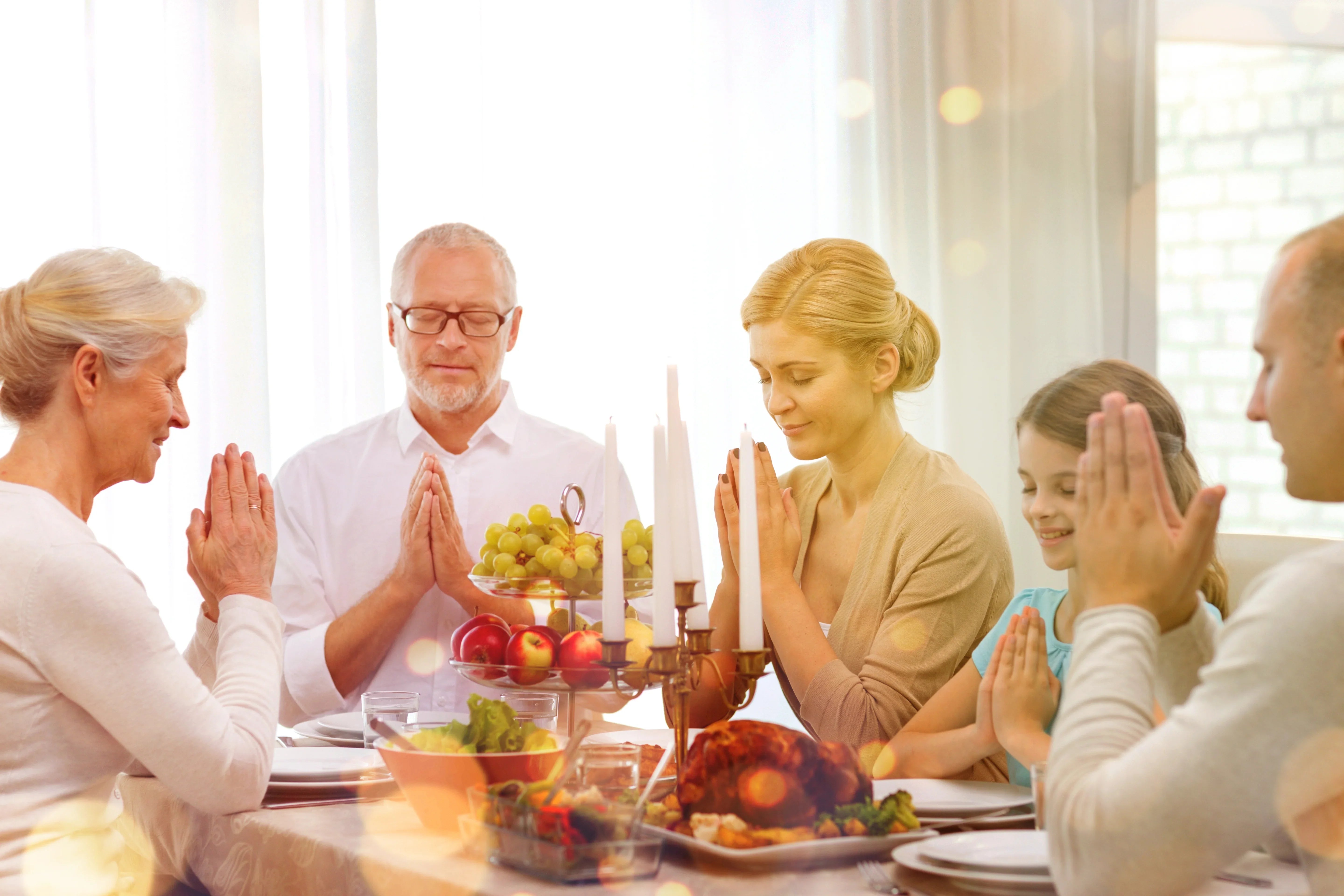 Family, Holidays, Generation And People Concept - Smiling Family Having Dinner And Praying At Home
