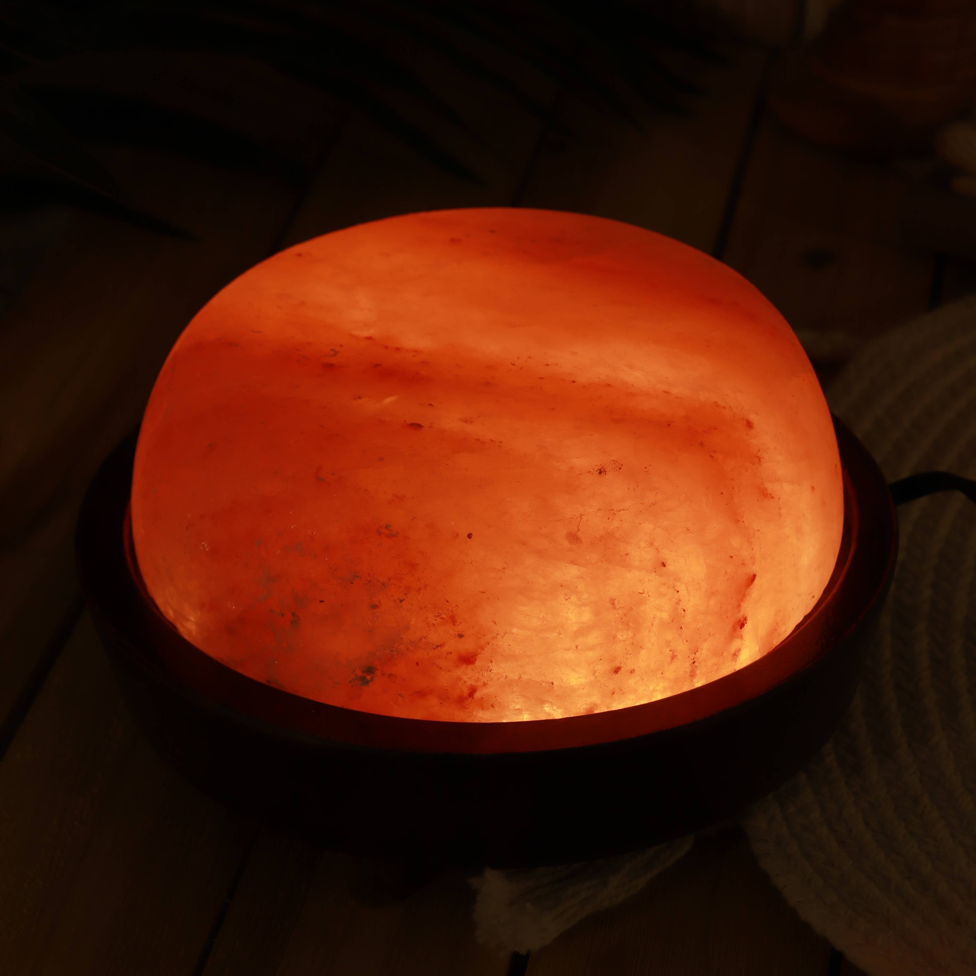 Round, glowing orange light source on a dark background
