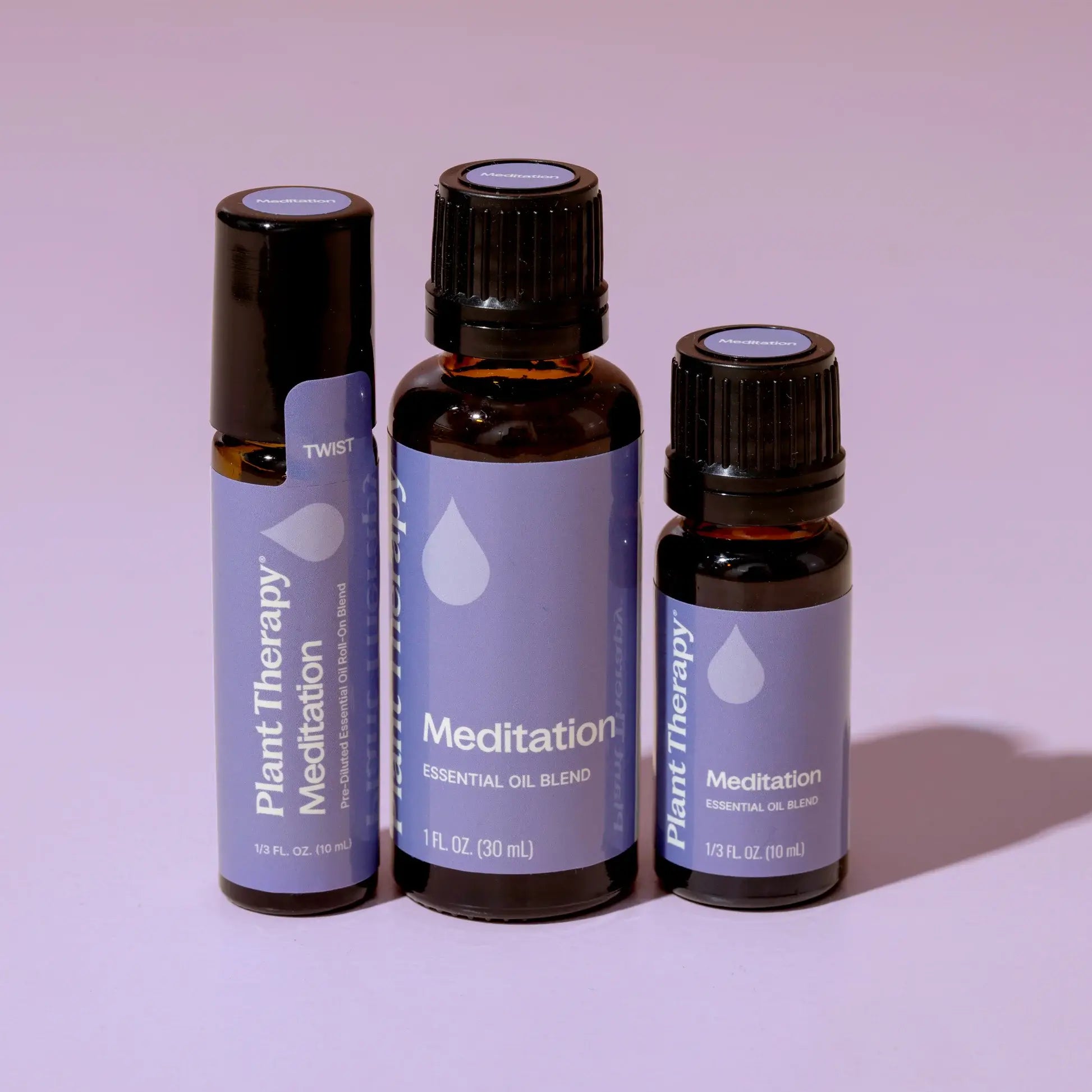 Three bottles of Plant Therapy Meditation essential oil blend on a light purple background - JOY - Journey Of You - Spiritual, Holistic, Empowering