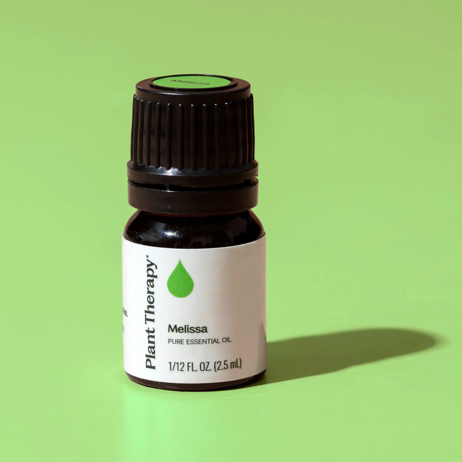 Bottle of Plant Therapy Melissa pure essential oil on a green background - JOY - Journey Of You - Spiritual, Holistic, Empowering