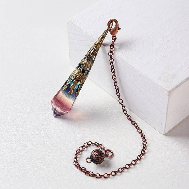 Decorative pendant with chain on a white surface