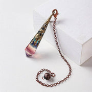 Decorative pendant with chain on a white surface