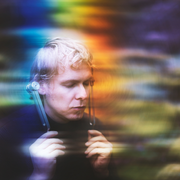 Person holding a sword with a colorful, blurred background - JOY - Journey Of You - Spiritual, Holistic, Empowering