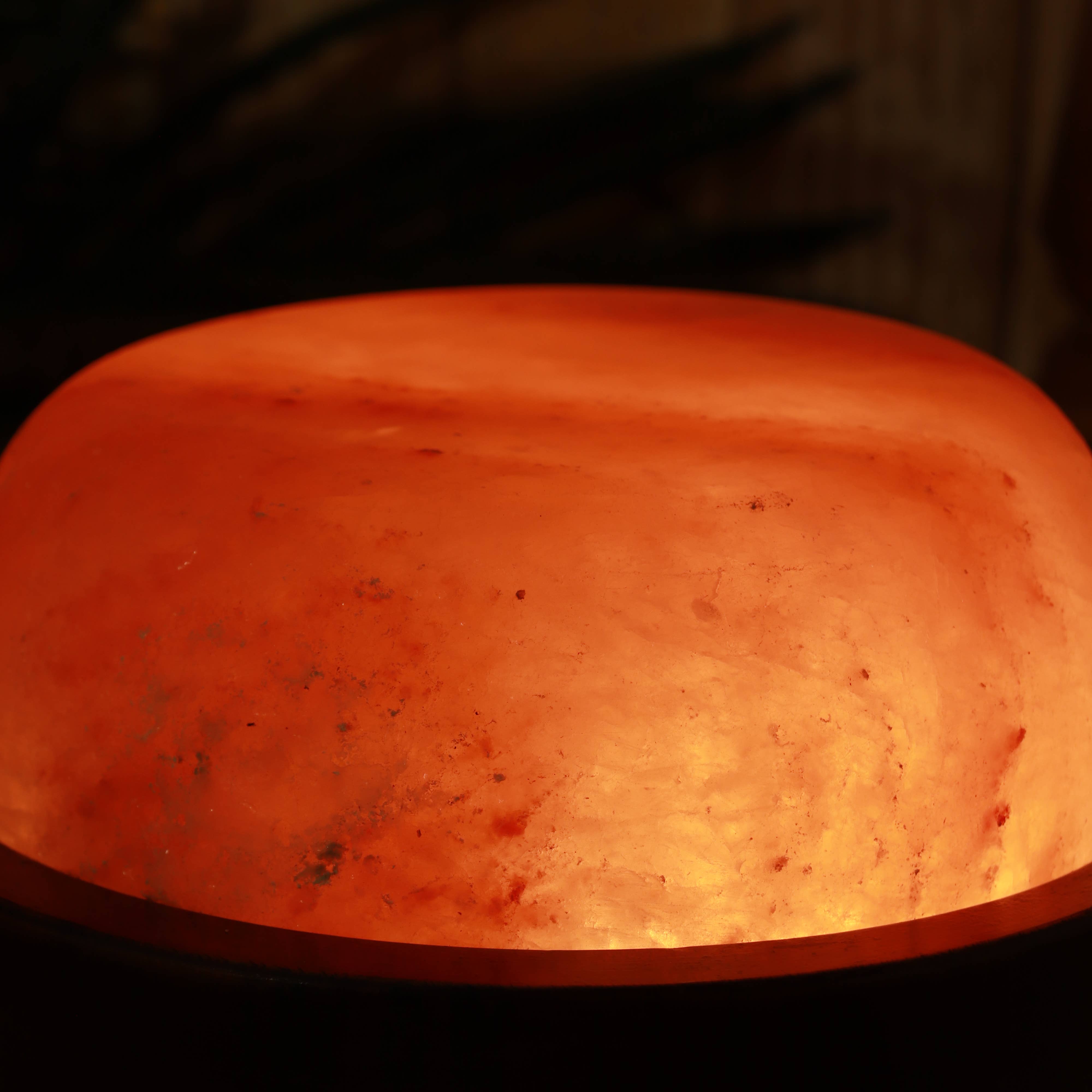 Close-up of a glowing red-orange stone in a dark setting