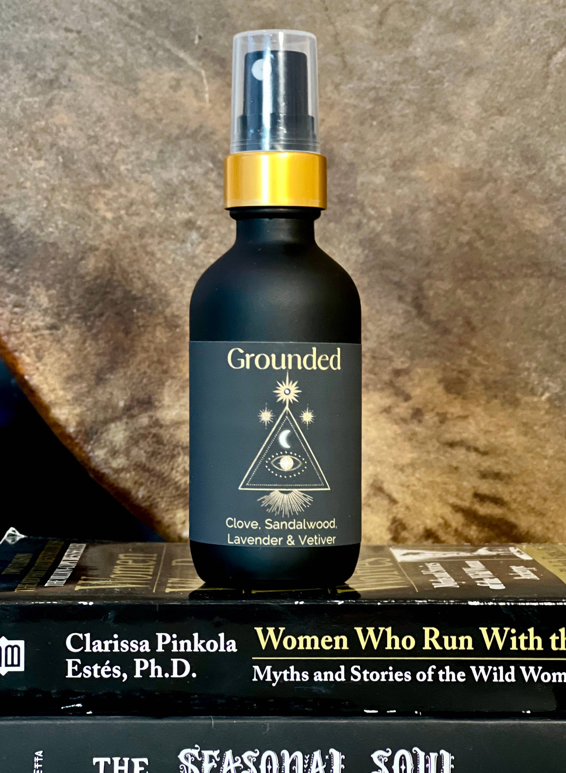 Bottle labeled 'Grounded' on a book with a textured background