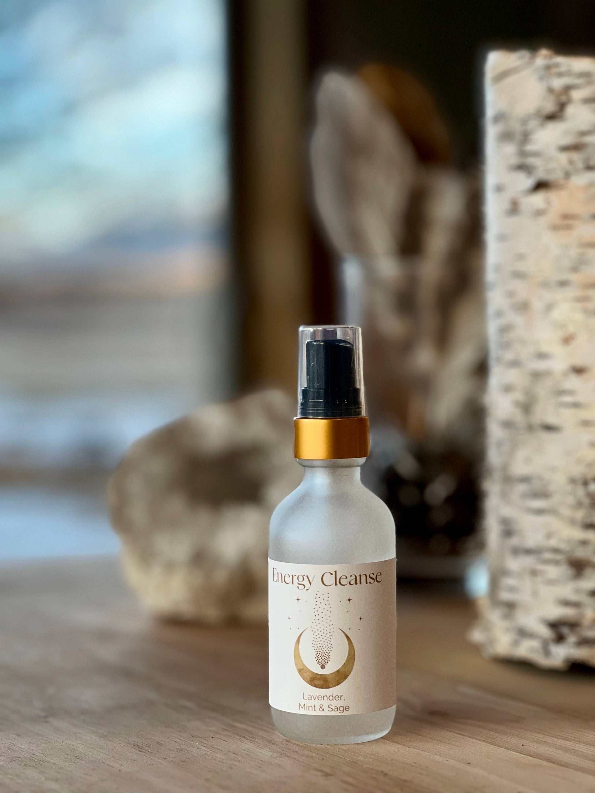 Bottle labeled 'Energy Cleanse' on a wooden surface with blurred natural background