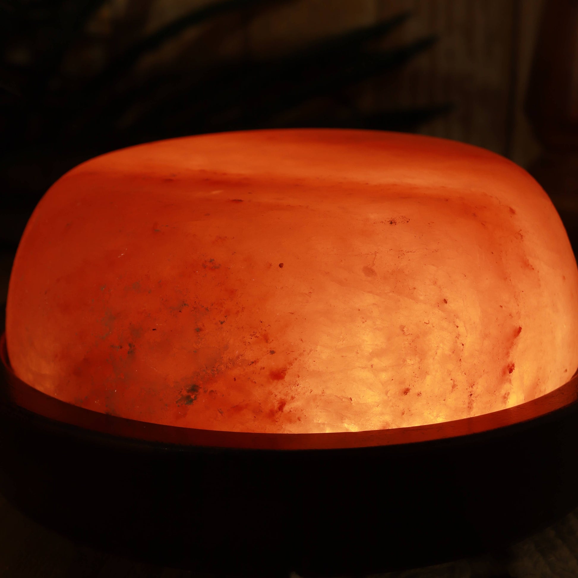 Himalayan salt lamp emitting a warm glow on a dark background
