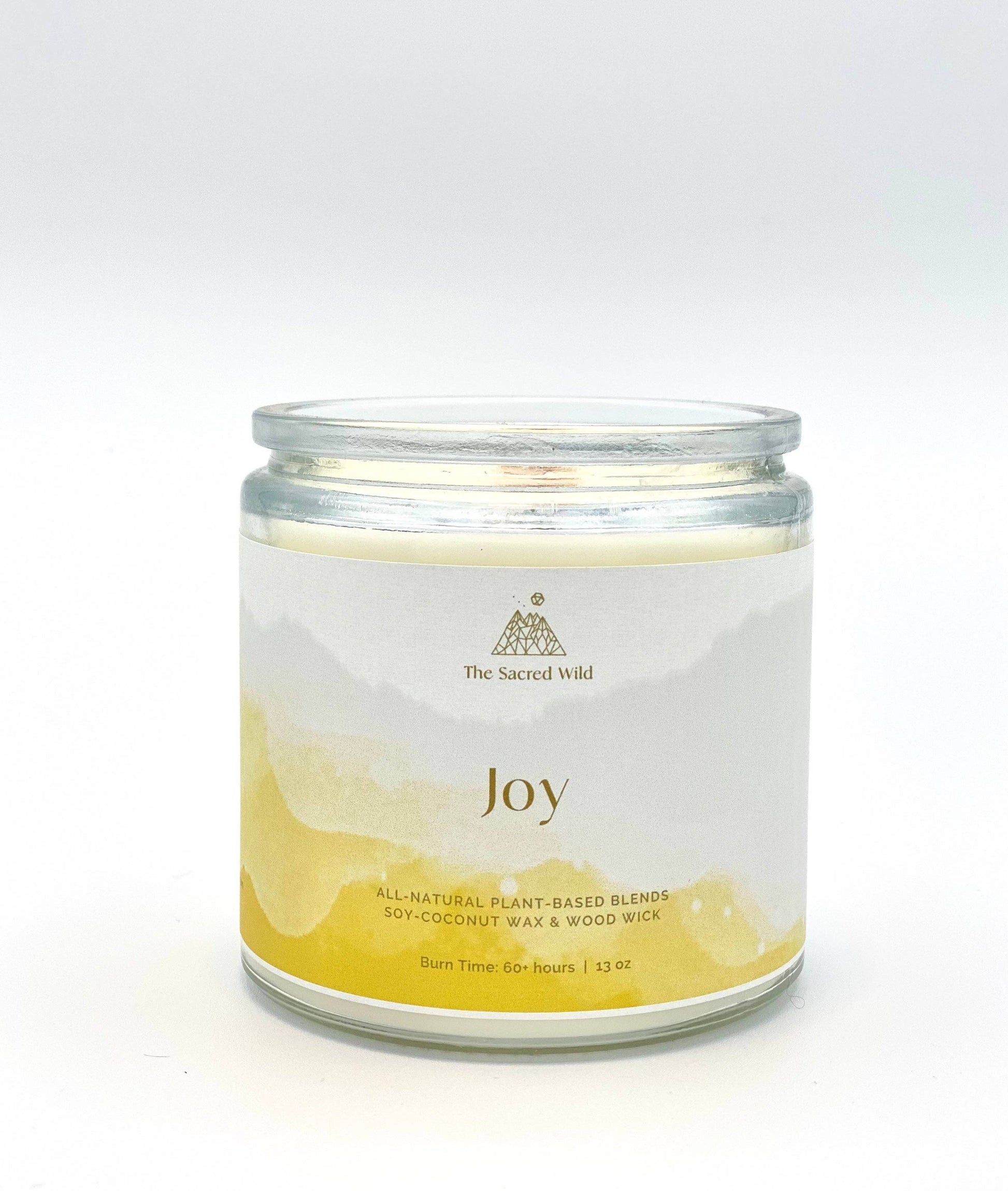 Candle jar labeled 'Joy' with a white label on a white background