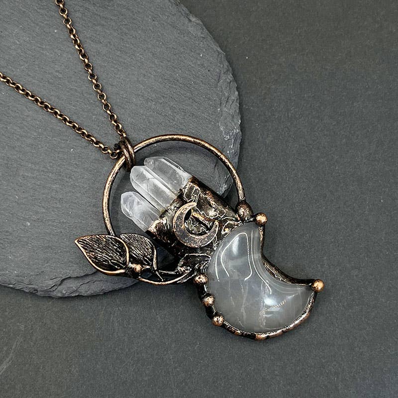 Necklace with a moonstone pendant on a dark gray background