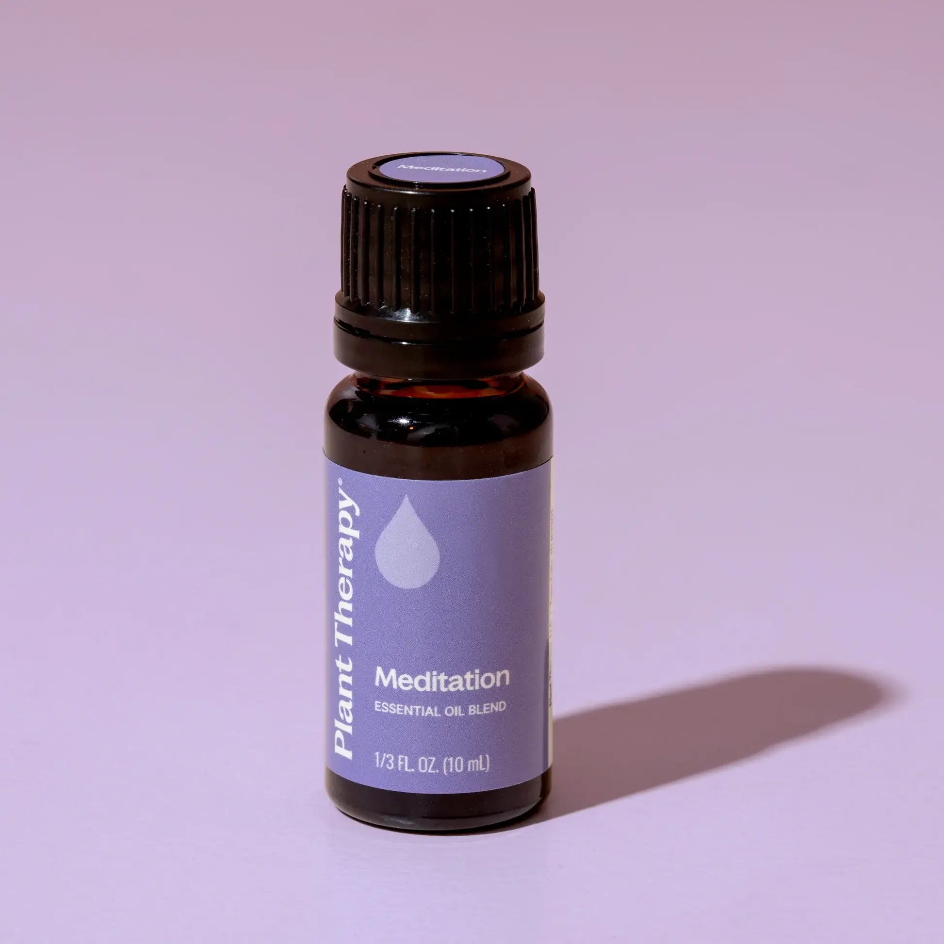 Essential oil bottle labeled 'Meditation' by Plant Therapy on a purple background - JOY - Journey Of You - Spiritual, Holistic, Empowering