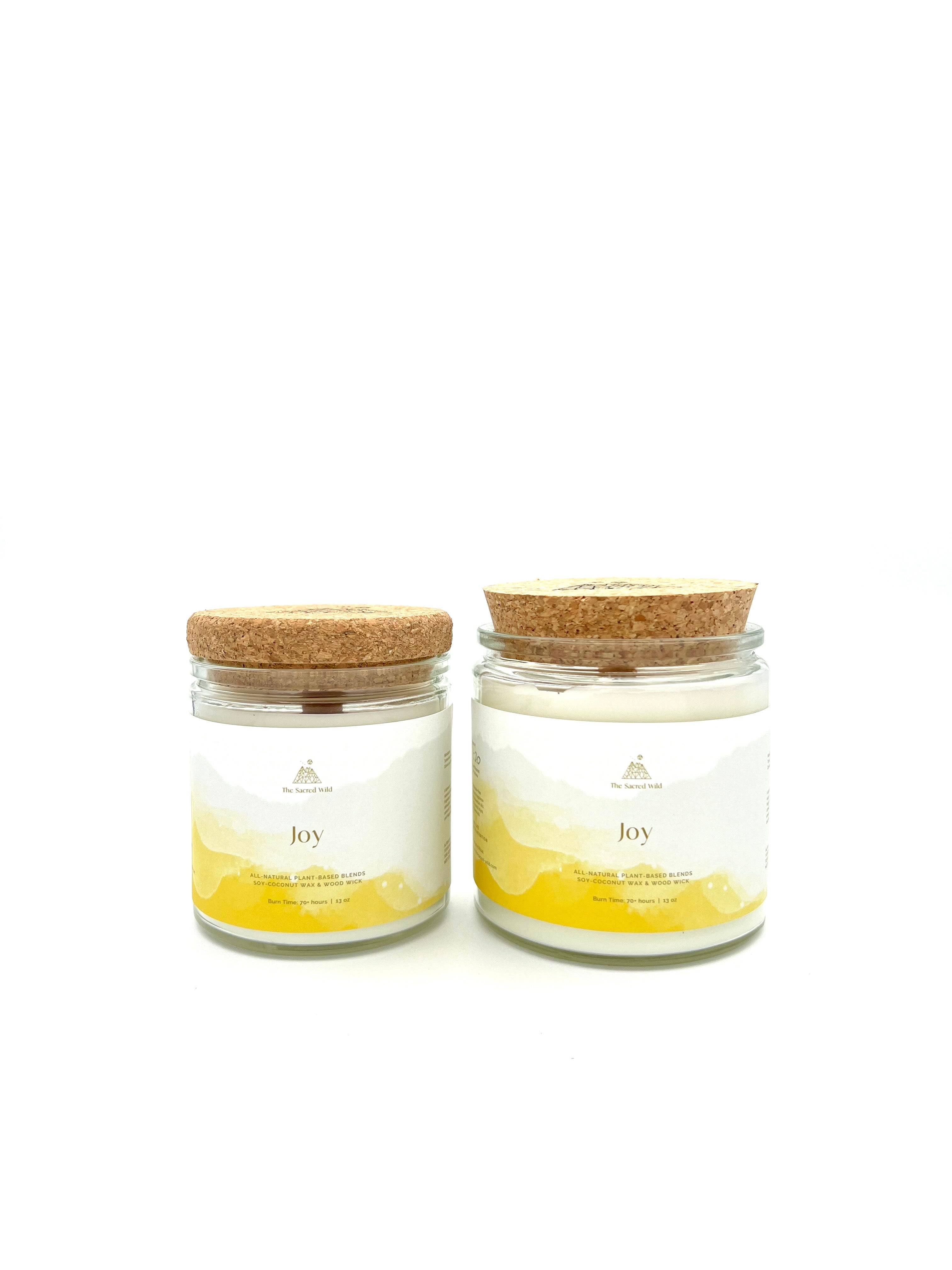 Two candles with cork lids on a white background