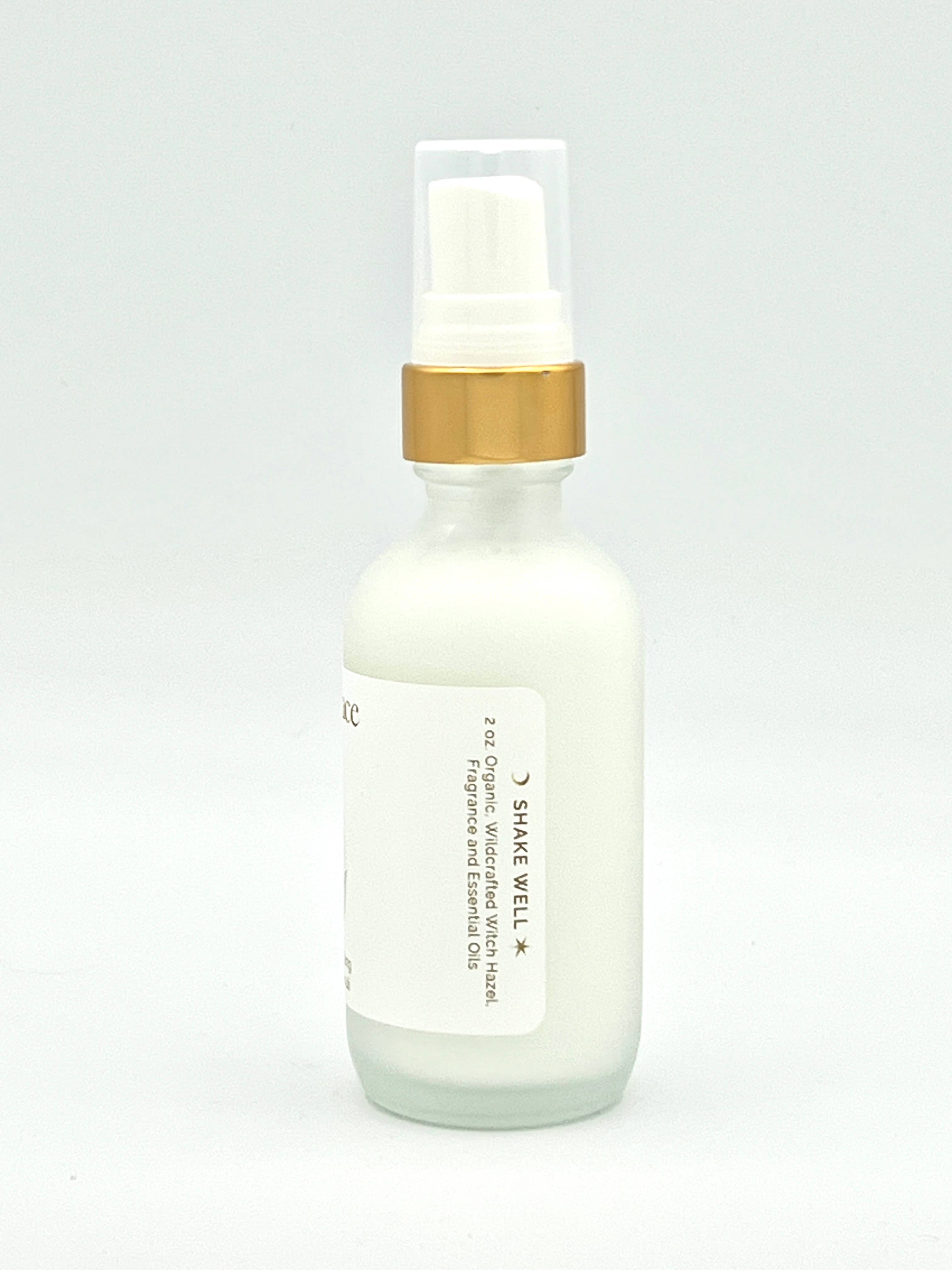Skincare serum bottle with gold cap on a light gray background