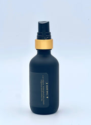 Dark blue bottle with gold cap on a light blue background