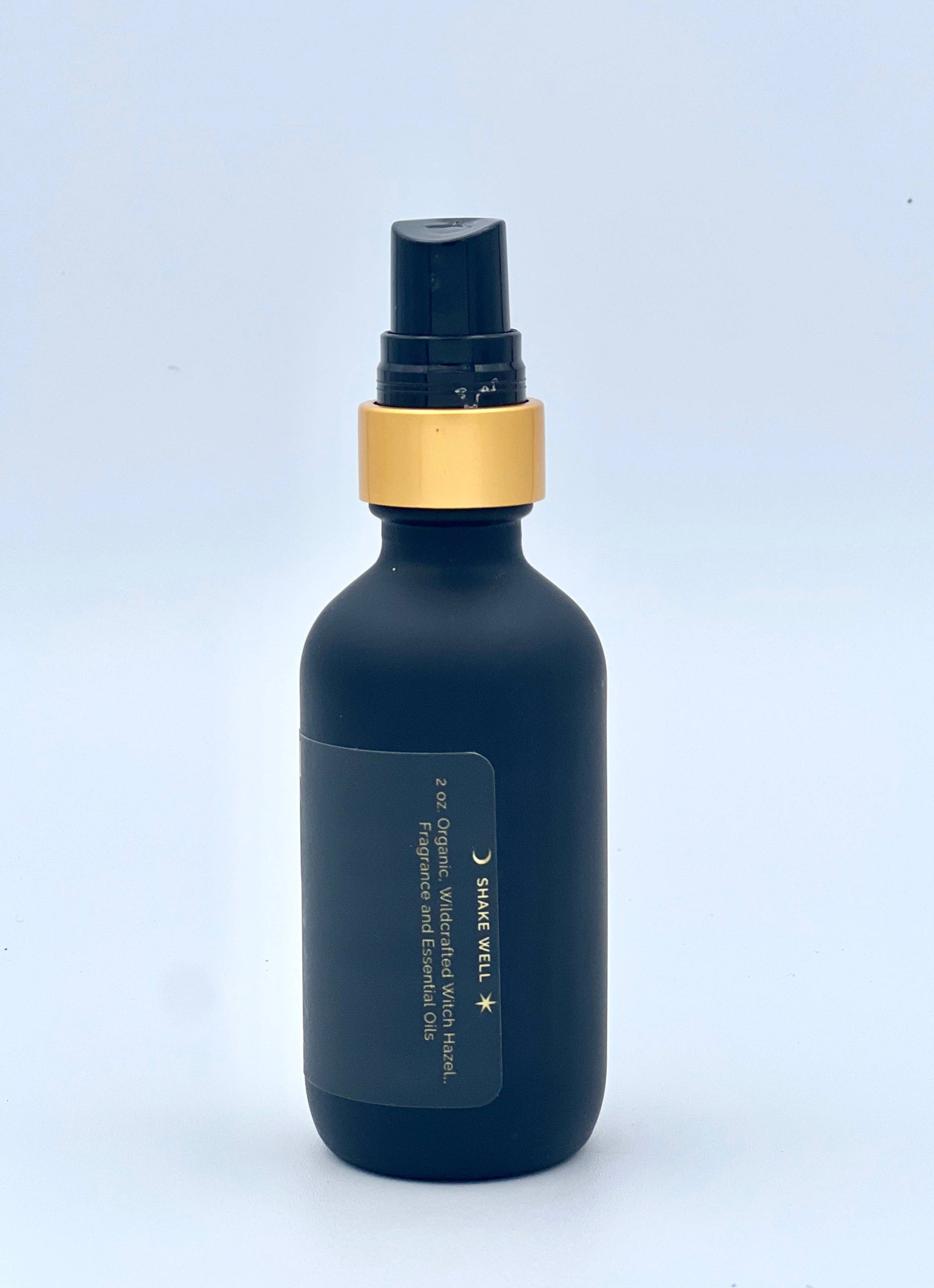 Dark blue bottle with gold cap on a light blue background
