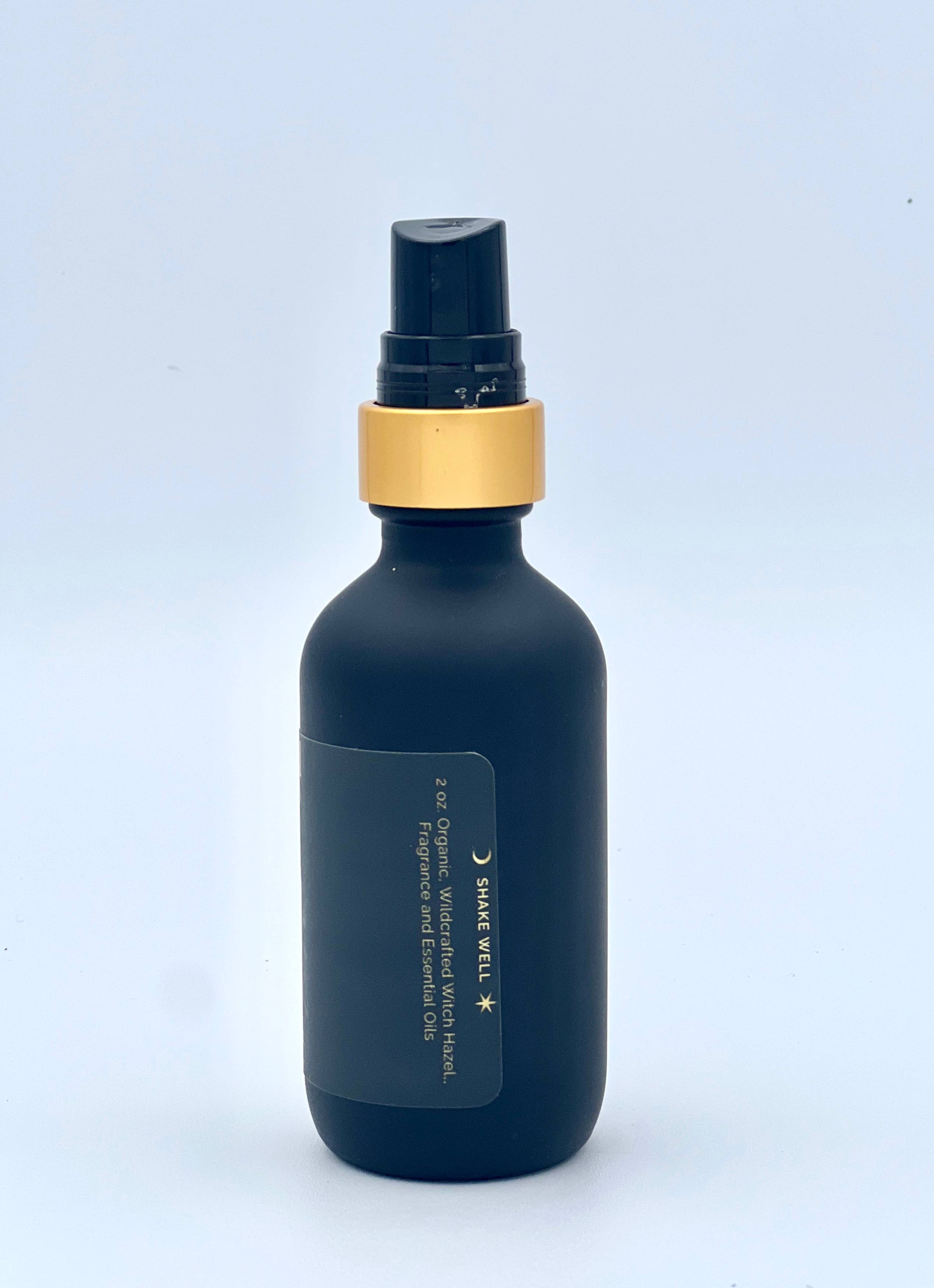 Dark blue bottle with gold cap on a light blue background