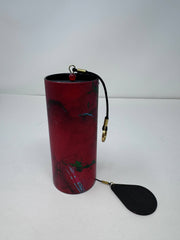 Red cylindrical container with a black paddle attached on a white background - JOY - Journey Of You - Spiritual, Holistic, Empowering