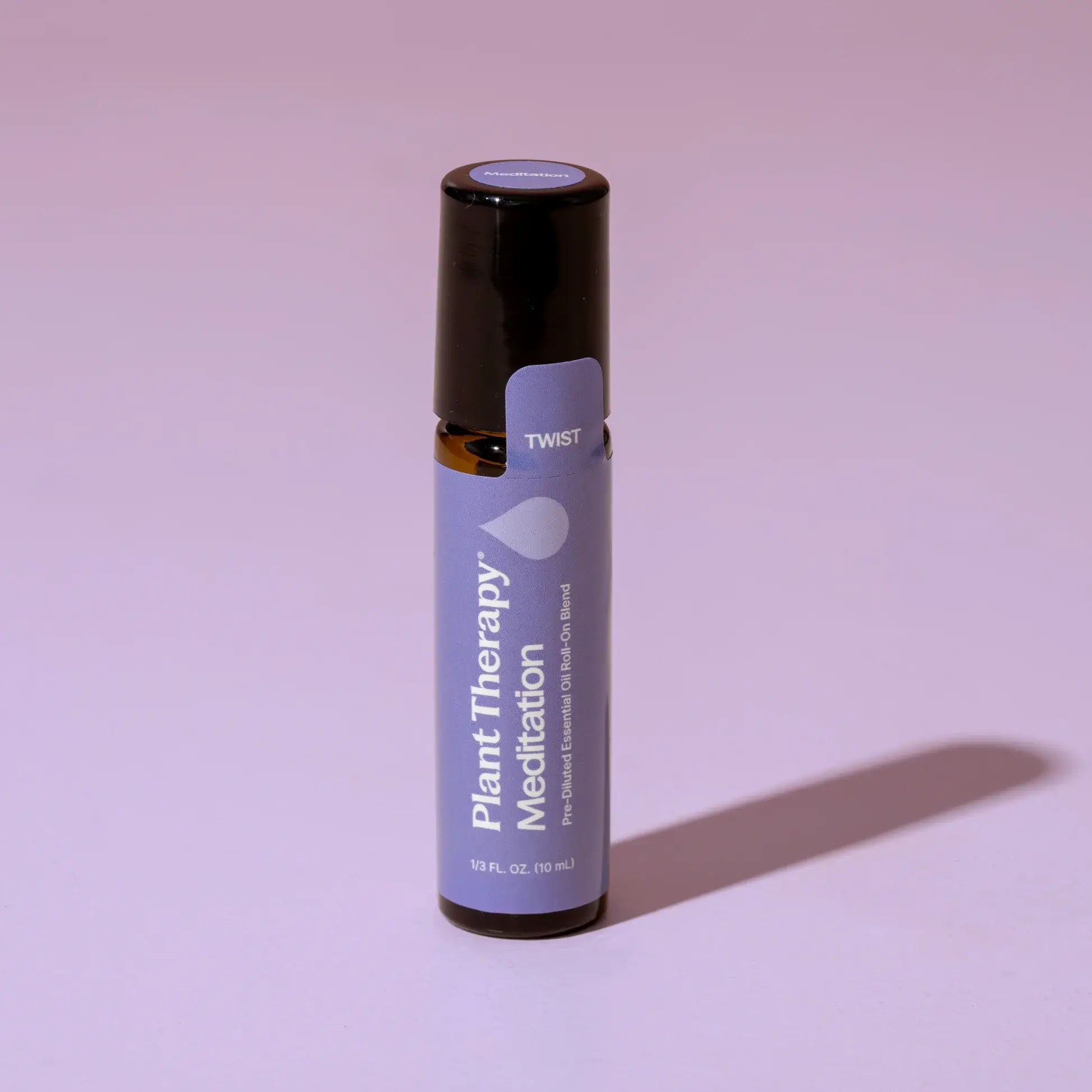 Roll-on bottle of Plant Therapy Meditation essential oil on a pink background - JOY - Journey Of You - Spiritual, Holistic, Empowering