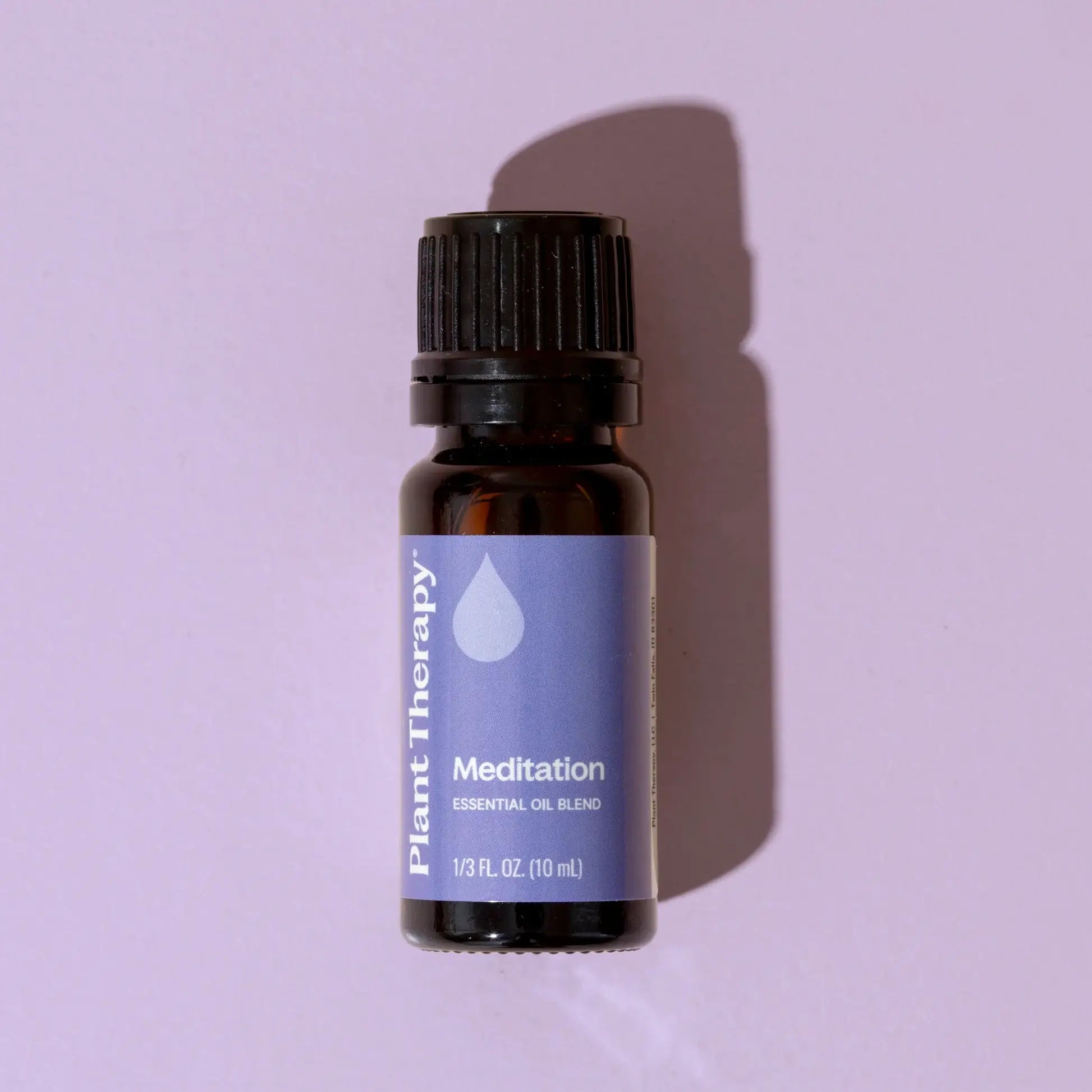 Essential oil bottle labeled 'Meditation' by Plant Therapy on a purple background - JOY - Journey Of You - Spiritual, Holistic, Empowering