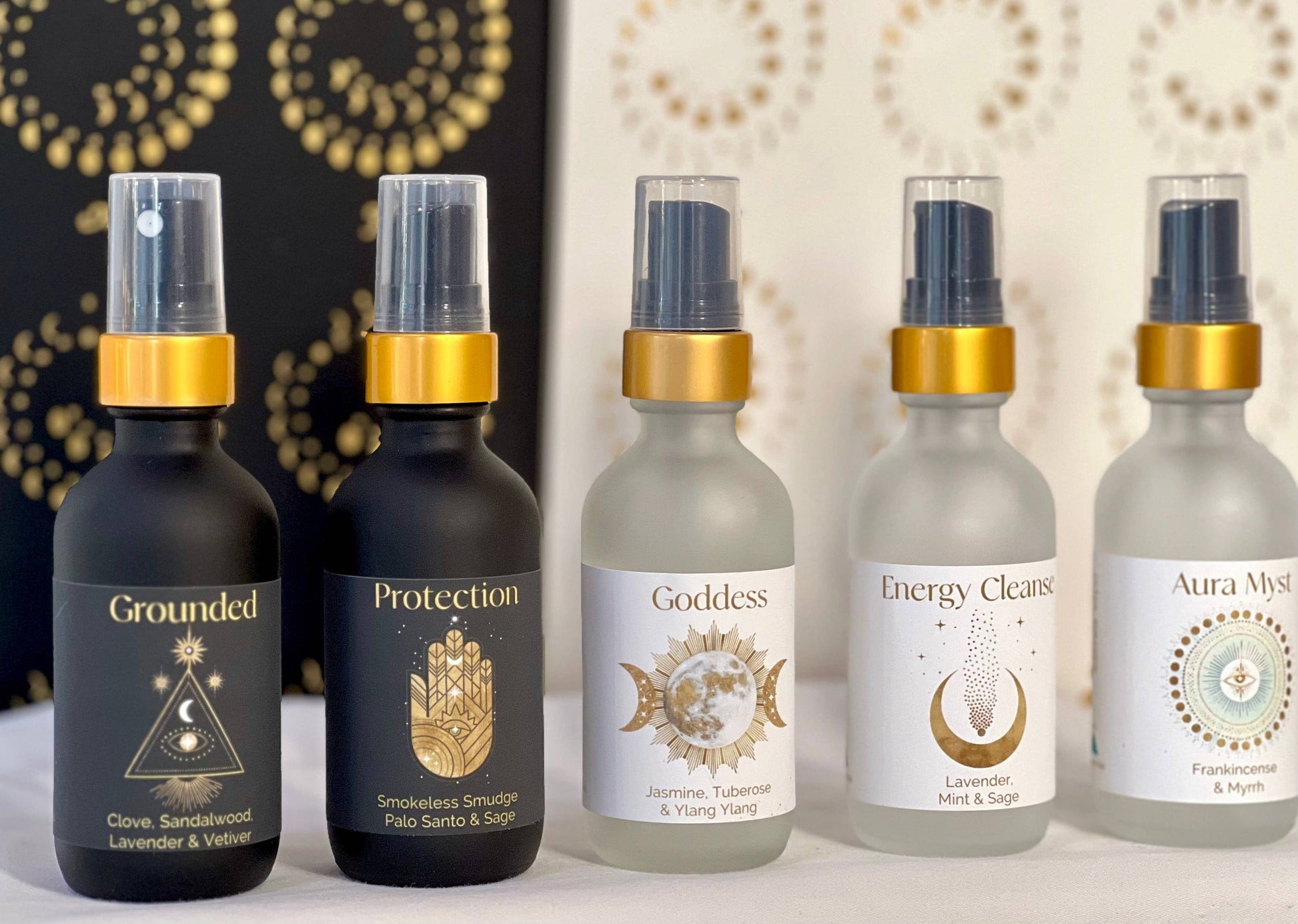 Five bottles of essential oils with labels on a decorative background