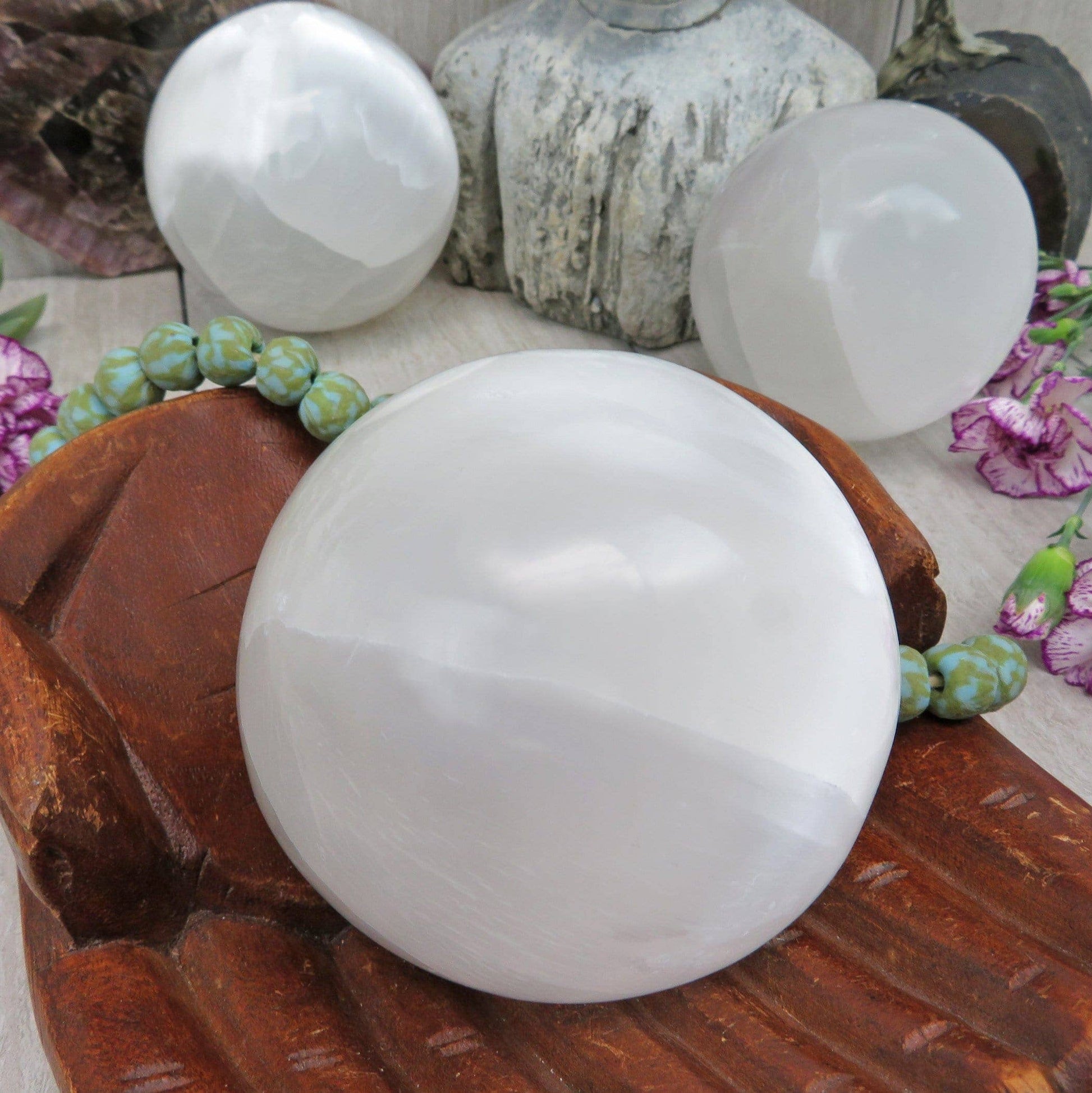 White spherical objects on a wooden surface with decorative elements