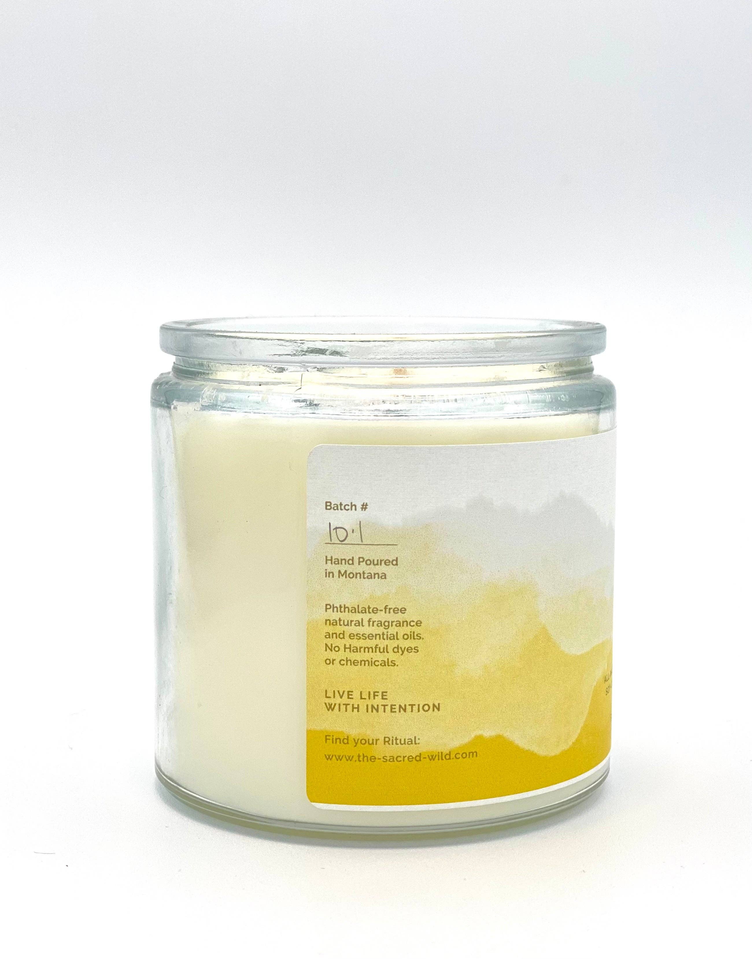 Candle in a glass jar with a label on a white background