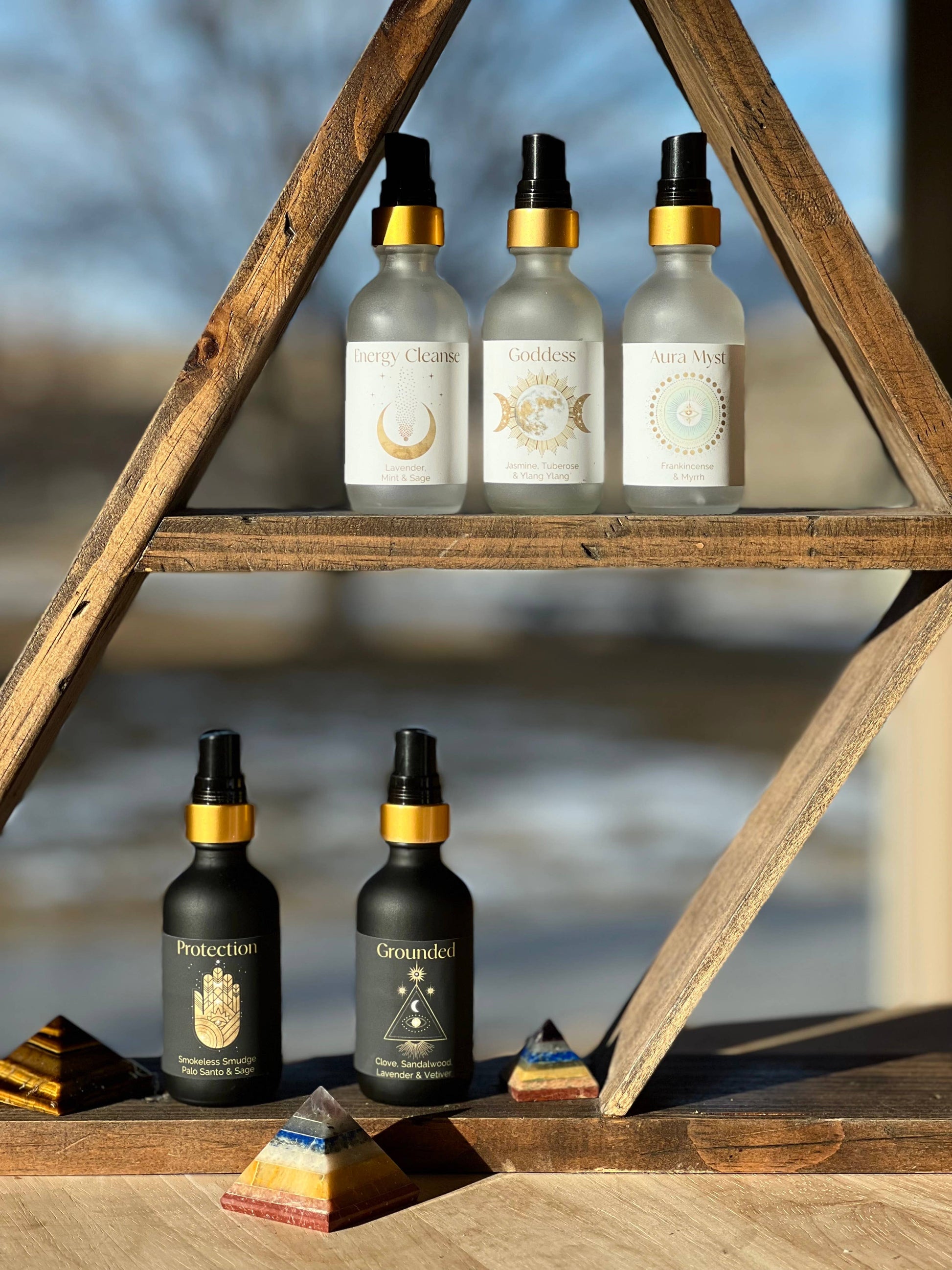 Set of bottles with labels on a wooden shelf outdoors