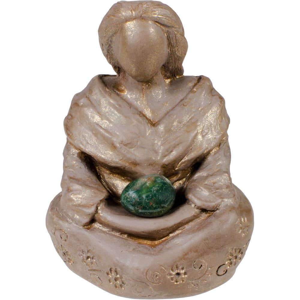 Small figurine of a person holding a green stone on a white background
