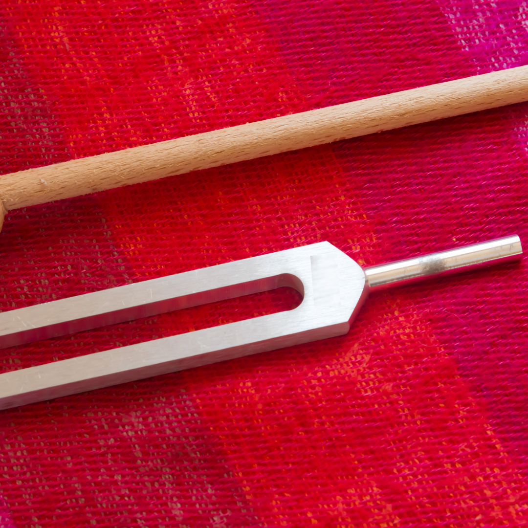 Tuning fork on a red fabric background