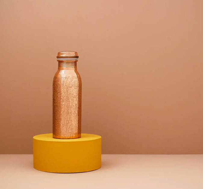 TAMRA EDEN COPPER BOTTLE - This bottle features a beautifully engraved floral motif and an elegant silhouette. 